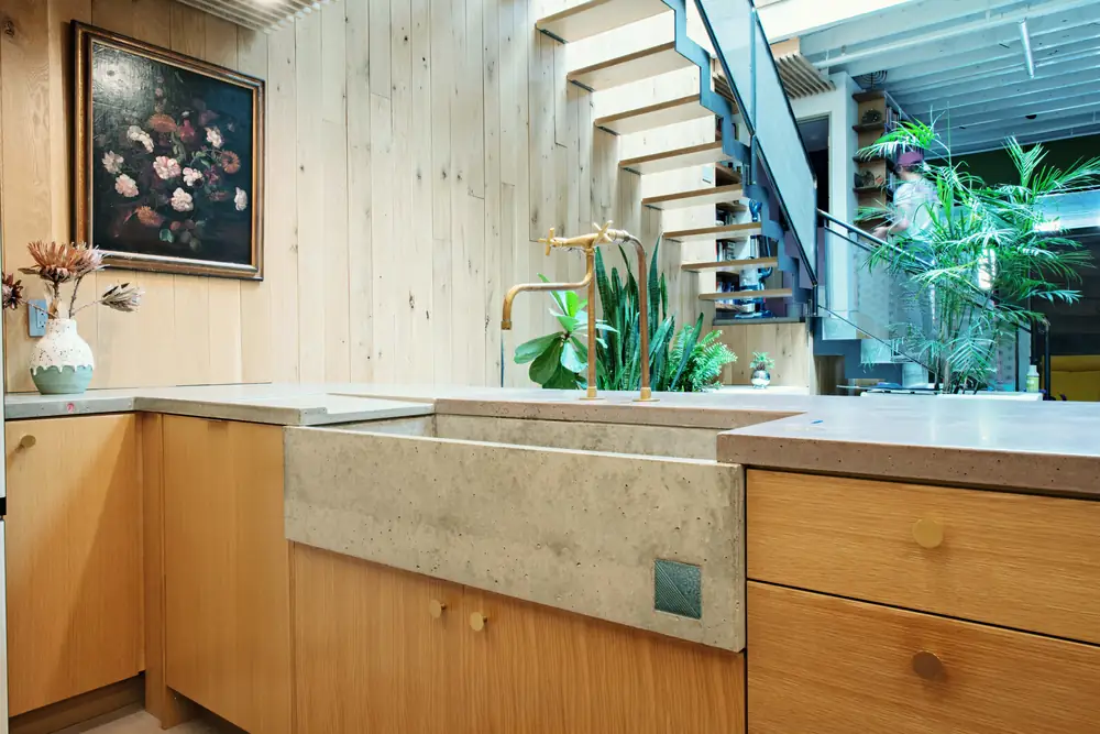 Cast concrete sink set into oak cabinetry